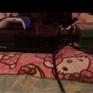 Black Gaming Console with Blue Controller and games